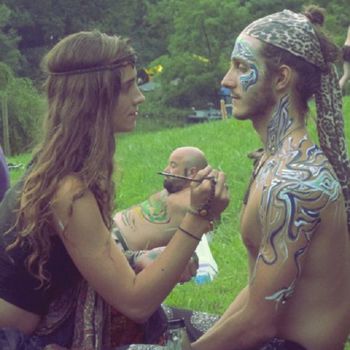 Woman painting man's face